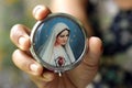 Hand holding and showing portrait of Mother Virgin Mary on the front rosary box cover. Royalty Free Stock Photo