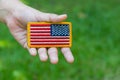 Hand holding Rounded American flag patch Royalty Free Stock Photo