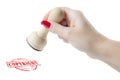 Hand holding a rubber stamp with the word copyright