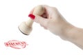 Hand holding a rubber stamp with the word discount