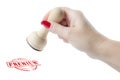 Hand holding a rubber stamp with the word premium