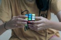 hand holding a Rubik\'s cube.