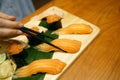 Hand holding salmon sushi using chopsticks - Steamed rice topped with fresh salmon sliced. Royalty Free Stock Photo