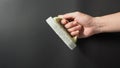 Hand is holding scourer pad with handle on black background Royalty Free Stock Photo