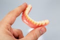 Hand holding a set of dentures