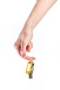 Hand holding set of keys with yellow nametag