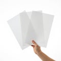 A hand holding several blank white sheets of paper ready for use Royalty Free Stock Photo