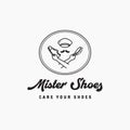 Hand holding shoes and brush for care and clean logo