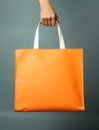 hand holding orange shopping tote bag Royalty Free Stock Photo