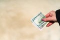 Hand holding showing dollar banknotes, giving or receiving money like tips or salary. Royalty Free Stock Photo