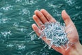 hand holding shredded paper for recycling symbol Royalty Free Stock Photo