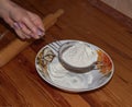 Hand holding sieve, sift flour. Preparing for baking.