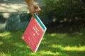 Hand holding a sign. Book belong to mama. Mothers day concept