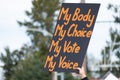A hand holding a sign supporting pro-choice during a rally for abortion justice.