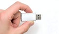 Hand Holding a Silver USB Flash Drive Against a White Background Royalty Free Stock Photo