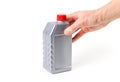 Hand holding silvery measuring bottle with red lid. Brake fluid Royalty Free Stock Photo