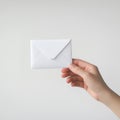 Hand Holding a Simple White Envelope, Clean and Minimalist Communication Concept Royalty Free Stock Photo