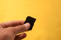 Hand holding a single Black SD Card for camera isolated background Royalty Free Stock Photo