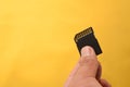 Hand holding a single Black SD Card for camera isolated background Royalty Free Stock Photo