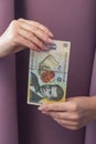 A hand holding a single Romanian 200 Lei banknote with a portrait of a famous writer Royalty Free Stock Photo