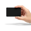 A hand holding a sleek black rectangular object against a white background Royalty Free Stock Photo
