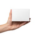 A hand holding a sleek white rectangular device against a plain background Royalty Free Stock Photo