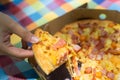 Hand holding sliced pizza cheese piece Italian food for lunch, close up. top view Italy traditional food delicious and tasty. Royalty Free Stock Photo