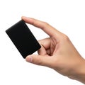 A hand holding a small black rectangle Royalty Free Stock Photo