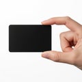 A hand holding a small black rectangular object with a green border Royalty Free Stock Photo