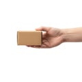 A hand holding a small brown cardboard box against a plain background Royalty Free Stock Photo