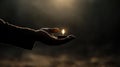 Hand holding small candle with flame in dark ambient lighting Royalty Free Stock Photo