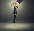 Hand holding small discontented businessman Royalty Free Stock Photo