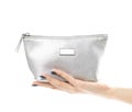 Hand holding a small silver purse. Close up. Isolated on a white background Royalty Free Stock Photo