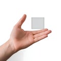 Hand holding small square object, isolated on white background Royalty Free Stock Photo