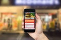 Hand holding smart phone with app food delivery order screen. application for restaurant service Royalty Free Stock Photo