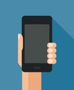 Hand holding smart phone on blue background