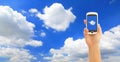 Hand holding smart phone with blue sky Royalty Free Stock Photo
