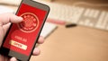 Hand holding smart phone with digital red packet for Chinese new year displayed on the screen Royalty Free Stock Photo