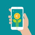 Hand holding smart phone with green leaves and euro coin as a flower on the screen Royalty Free Stock Photo