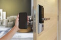 Hand holding smart phone to Open digital door locking system