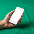 A smartphone with a blank white screen against a solid green backgroun Royalty Free Stock Photo