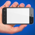 Hand holding smartphone on blue background.