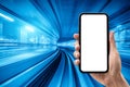 Hand holding smartphone with blue motion blur background.