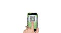 Hand holding smartphone displaying a qr code on a green screen Royalty Free Stock Photo