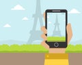 Hand Holding Smartphone with Eiffel Tower on the Screen Vector Illustration