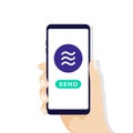 Hand holding smartphone with Libra coin currency. Online Crypto currency pay and send concept.