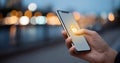 A hand holding a smartphone with the lock icon displayed on its screen, in an urban setting at night time Royalty Free Stock Photo