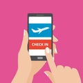 Hand holding smartphone with online check in button and airplane icon on screen. Concept of mobile application.