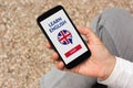 Hand holding smartphone with online learn English concept on screen