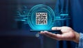 hand holding a smartphone with a QR code displayed, surrounded by a digital interface Royalty Free Stock Photo